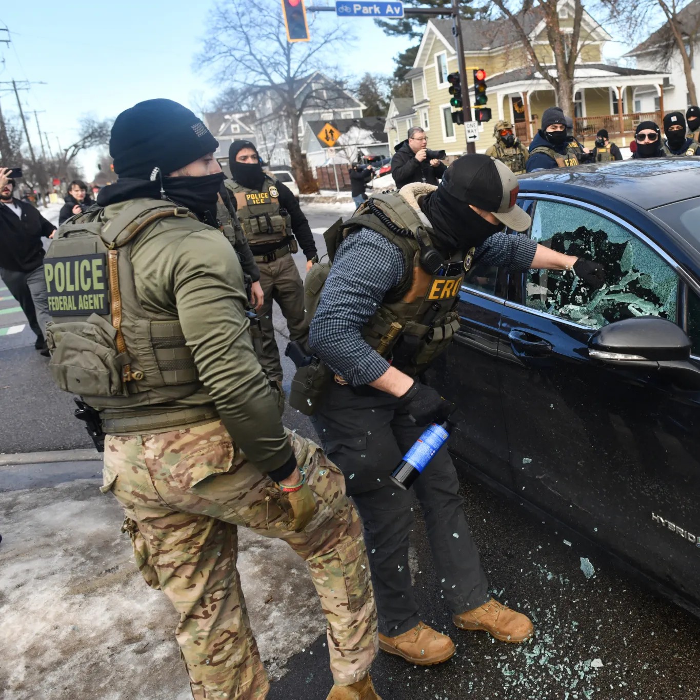 DHS agents smash a car window in Minneapolis during Operation Metro Surge